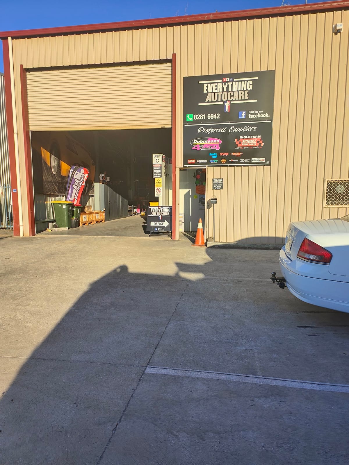 The Everything Autocare workshop frontage on Stanbel Road with the roller door open and the sign beside it